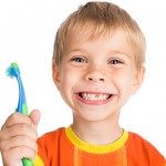 boy without one teeth with toothbrush